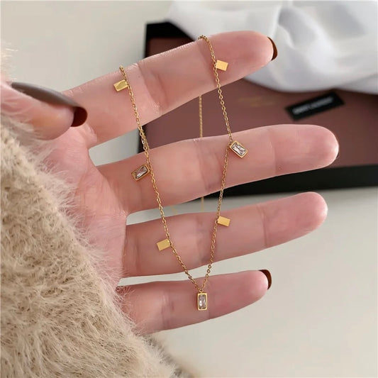 Gold Dangle Charm Choker Necklace with Baguette Zircon & Geometric Charms